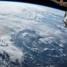 An orbital view of one of Earth's oceans, with significant cloud cover.